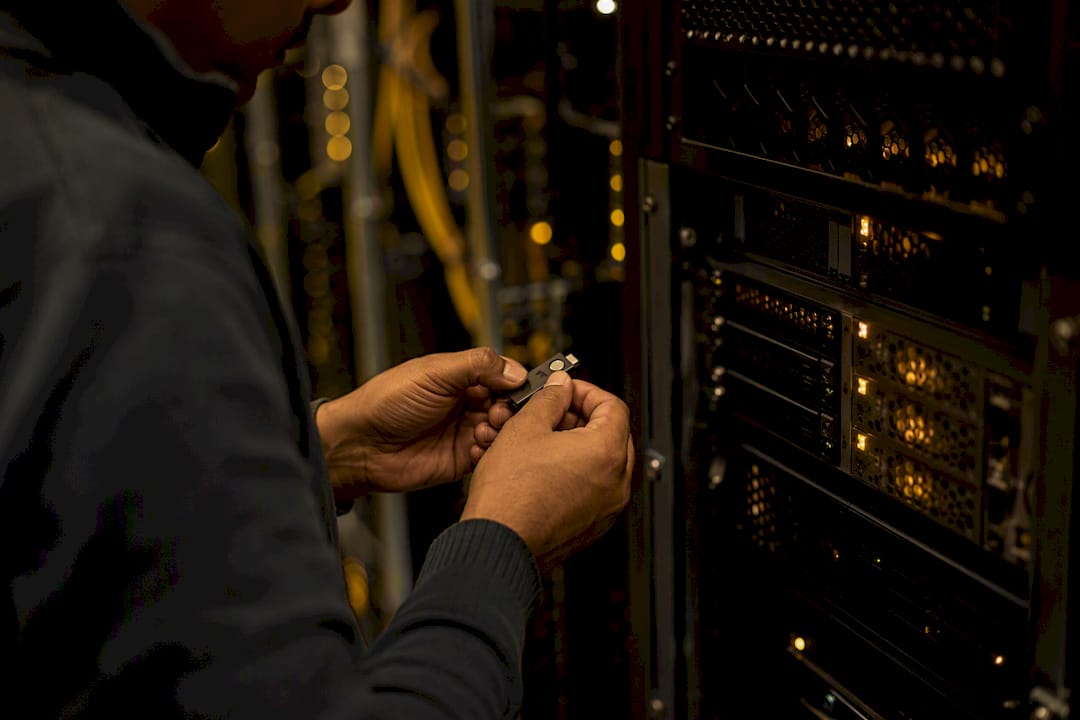 Hands activating security token in server room