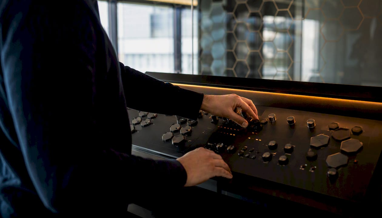 Hands adjusting hexagonal control panel