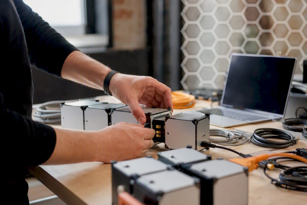 Hands assembling modular AI automation components